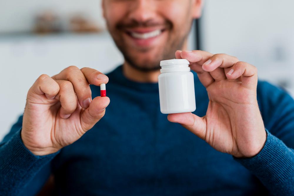 A Patient Holding A Pill and the Bottle
